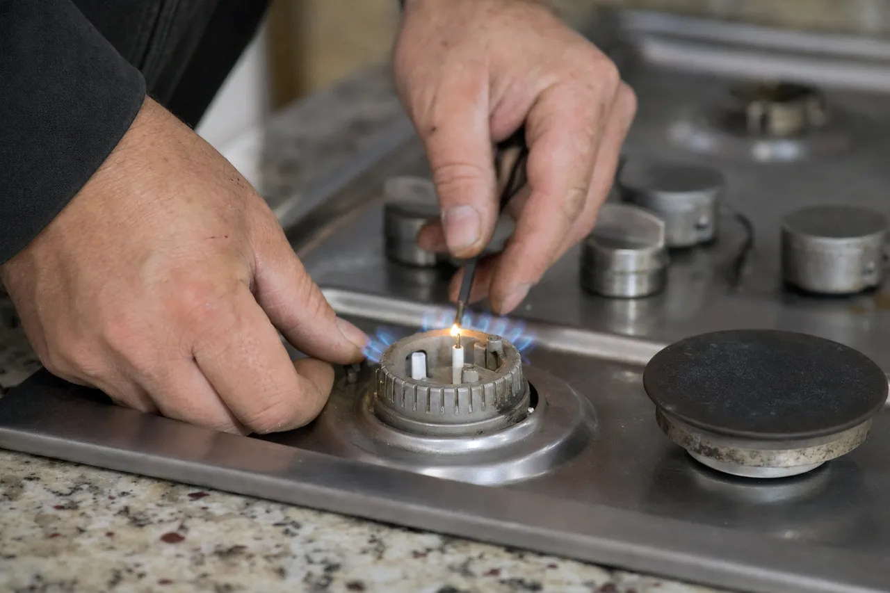 Technician adjusting a gas cooktop burner in an Irvington kitchen